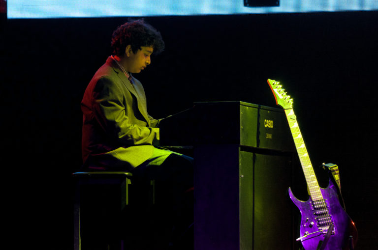 Boy in Suit Playing Casio